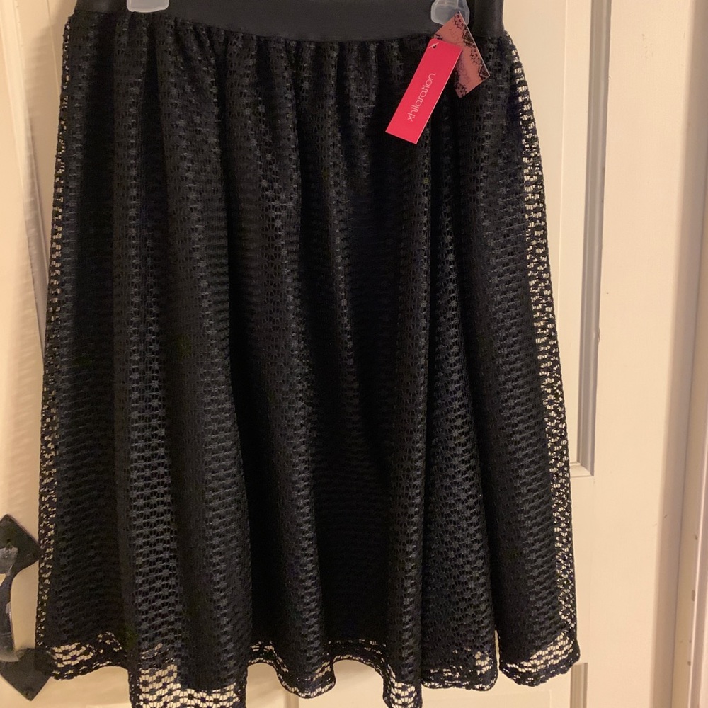 SUPER cute skirt. Black nylon with overlay.